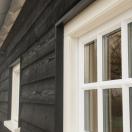 Zwart huis met witte kozijnen - 1